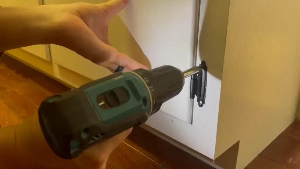 Aligning the hinges with the cabinet doors