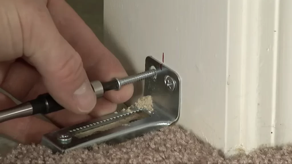 Insert the top pivot pin into the top bracket